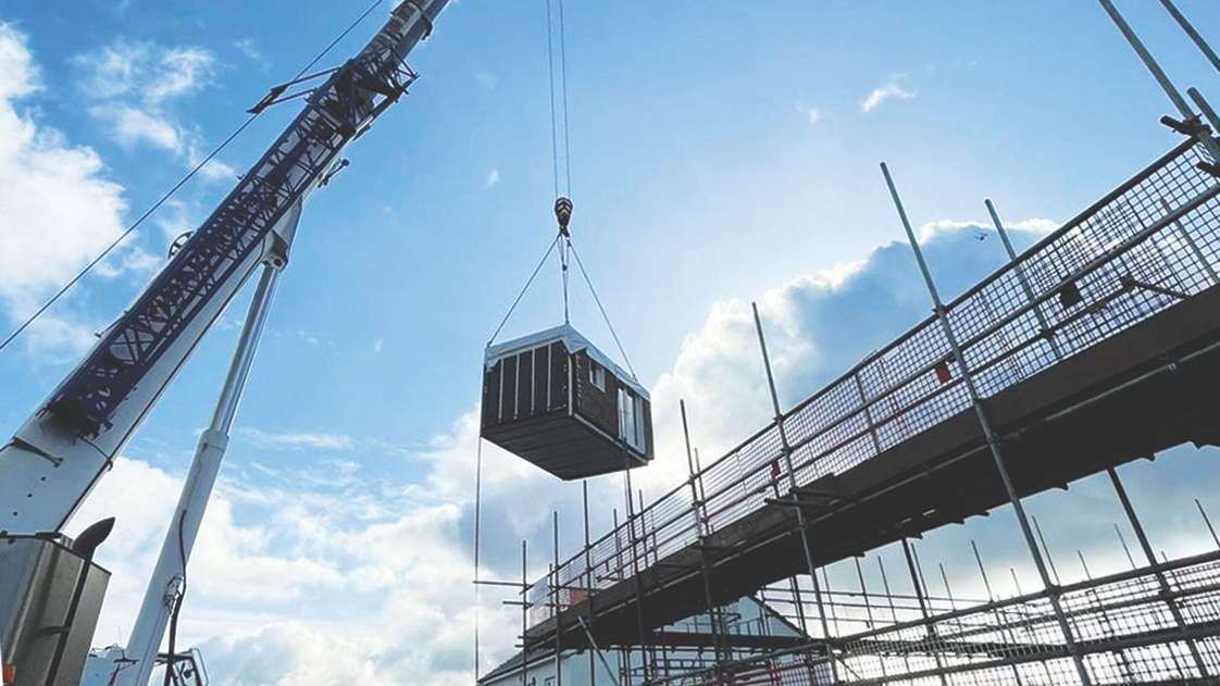 A steel module is craned into place at Coed Darcy