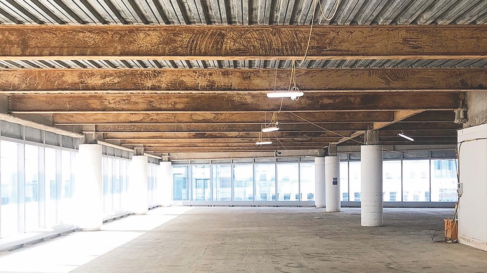 Rusty steel beams at 25 North Colonnade prior to blast-cleaning