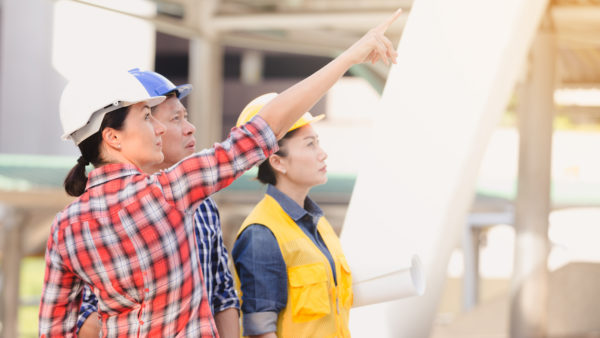 Engineers, men and women, working on construction site