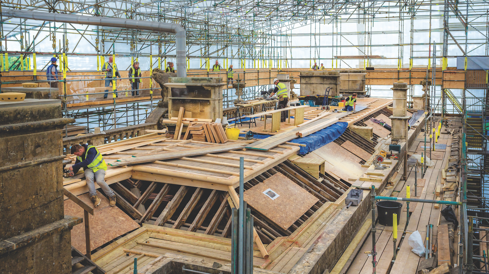 Stonemasons and roofers at work on major roof repairs at Dyrham Park, a historic mansion in Gloucestershire. Image: Dreamstime