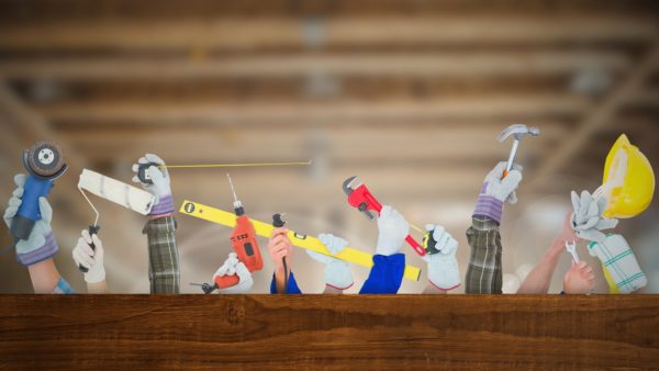 Hands with tools. Image: Dreamstime