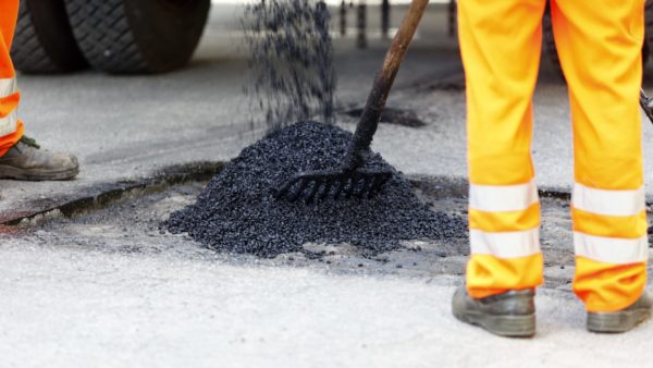 Worker repairing a pothole