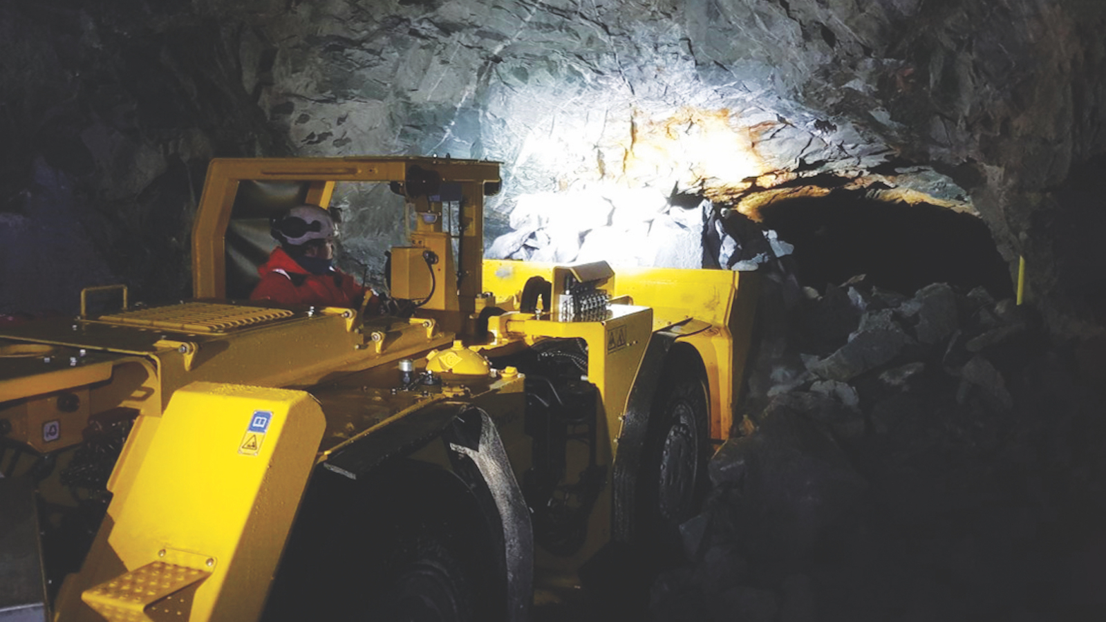 A wheeled loader in an adit during construction of the Cononish mine