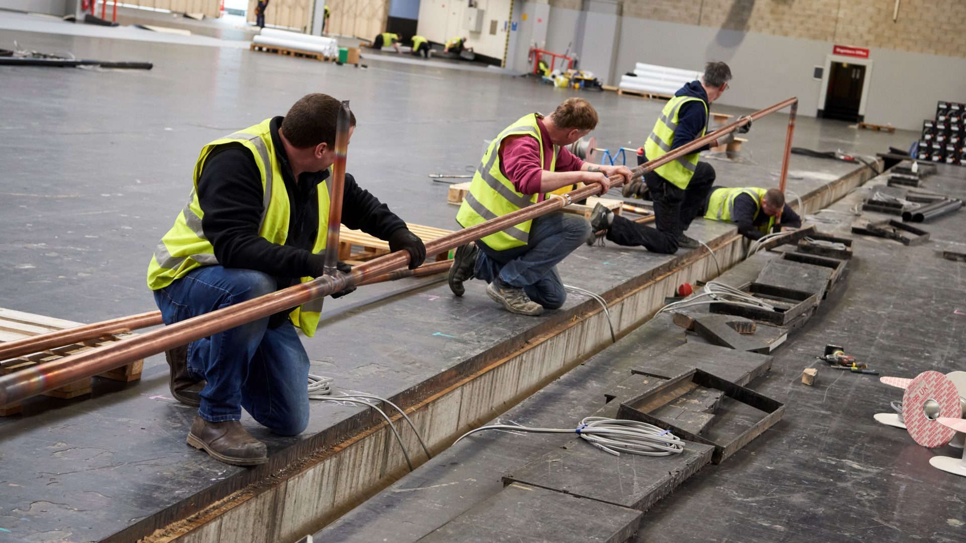 Interserve workers practice social distancing while constructing the NHS Nightingale hospital at Birmingham NEC