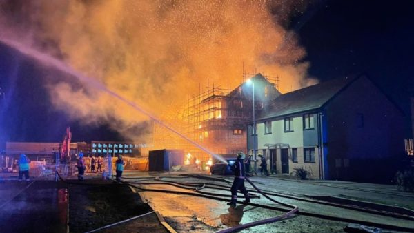 A firefighter tackles the blaze at the Keepmoat Homes site (Image courtesy of Cambridgeshire Fire and Rescue Service)