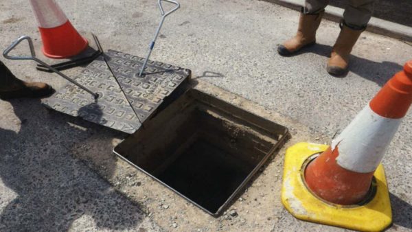 An exposed manhold cover with a yellow-based, red traffic cone to the right of the image (Image: HSE)