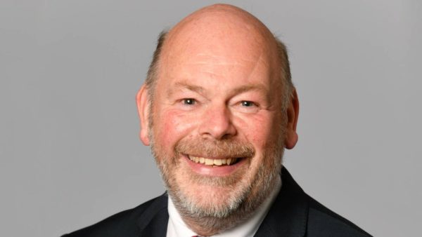 Headshot of a man smiling at the camera.