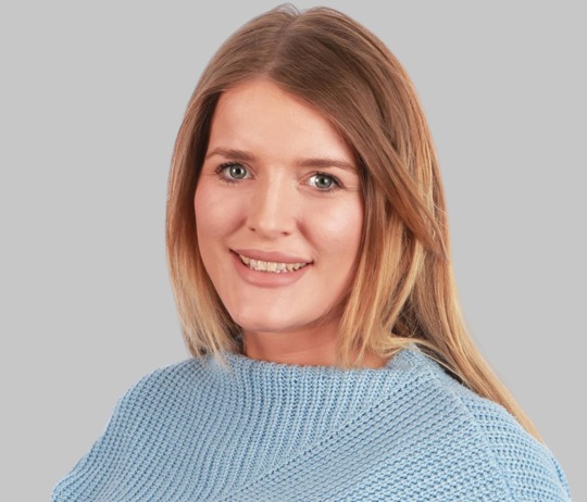 A woman smiling at the camera.