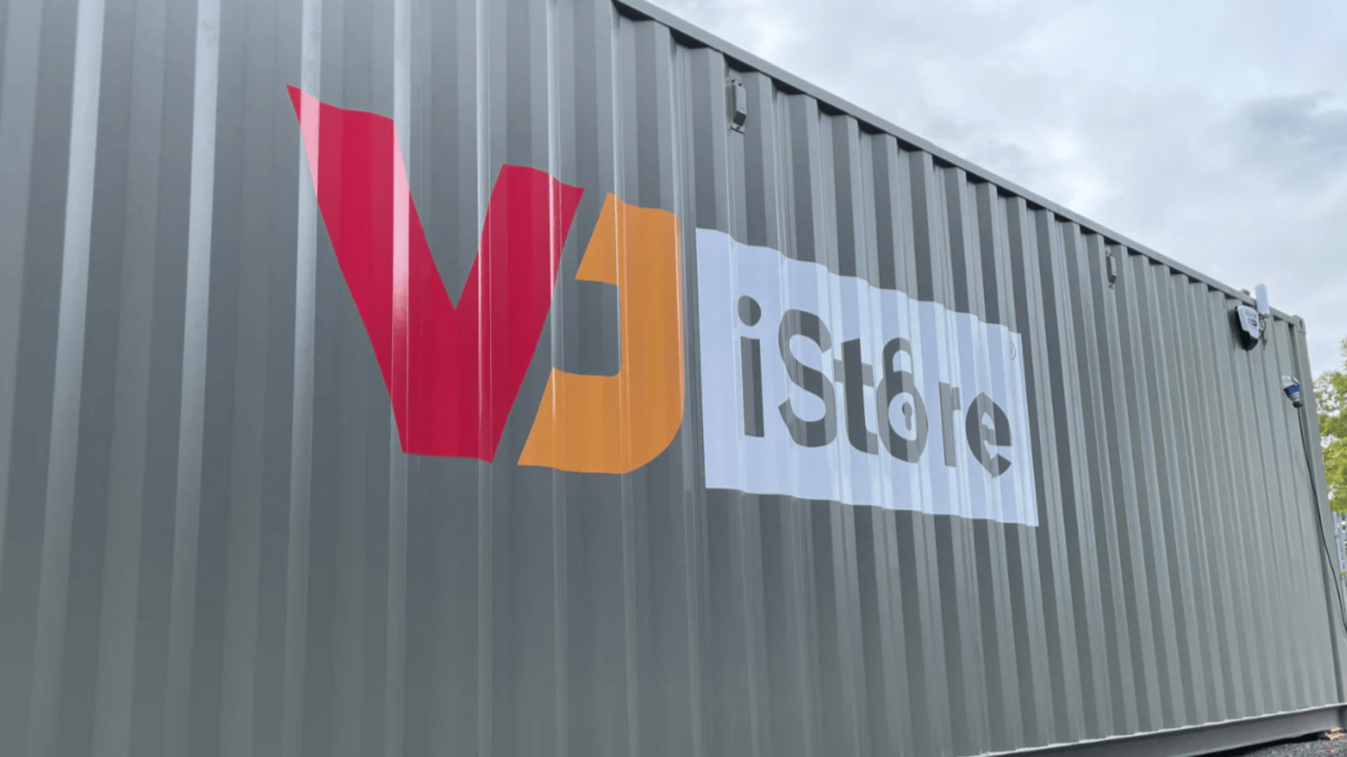 Amazon Locker - A big grey container with the word 'VJ iStore' on it.