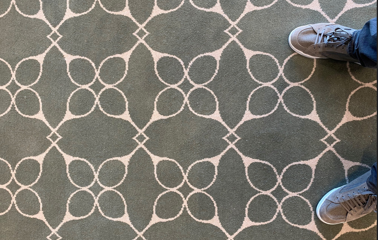 A carpet and two shoes