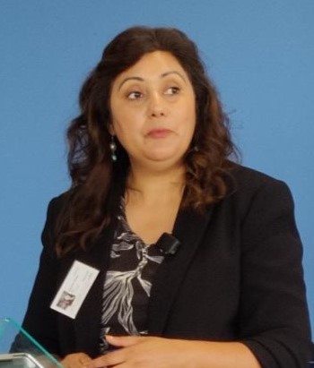 A woman speaking at a lectern