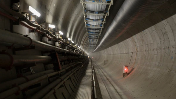View of the inside of a huge concrete tunnel.