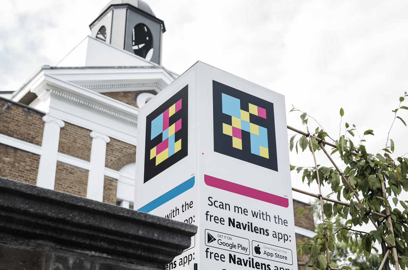 A prop explaining an app scanning process and a building in the background.