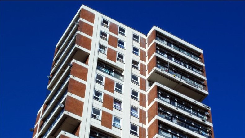 BSR Building Control View of a high-rise building from below against a blue sky.