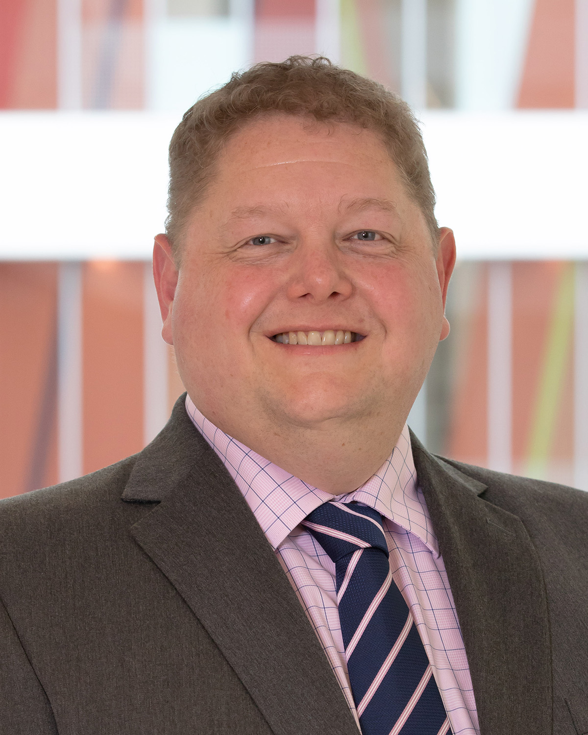 Headshot of a man smiling at the camera.