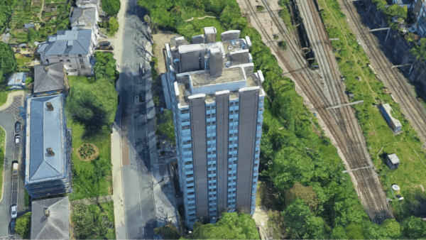 Aerial view of a high-rise building that's been stripped of its cladding.