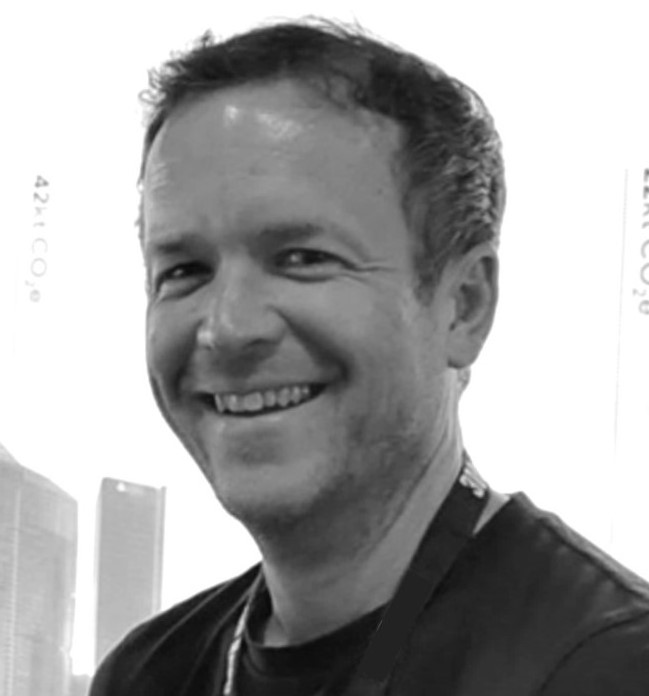 Mugshot of a man smiling at the camera.