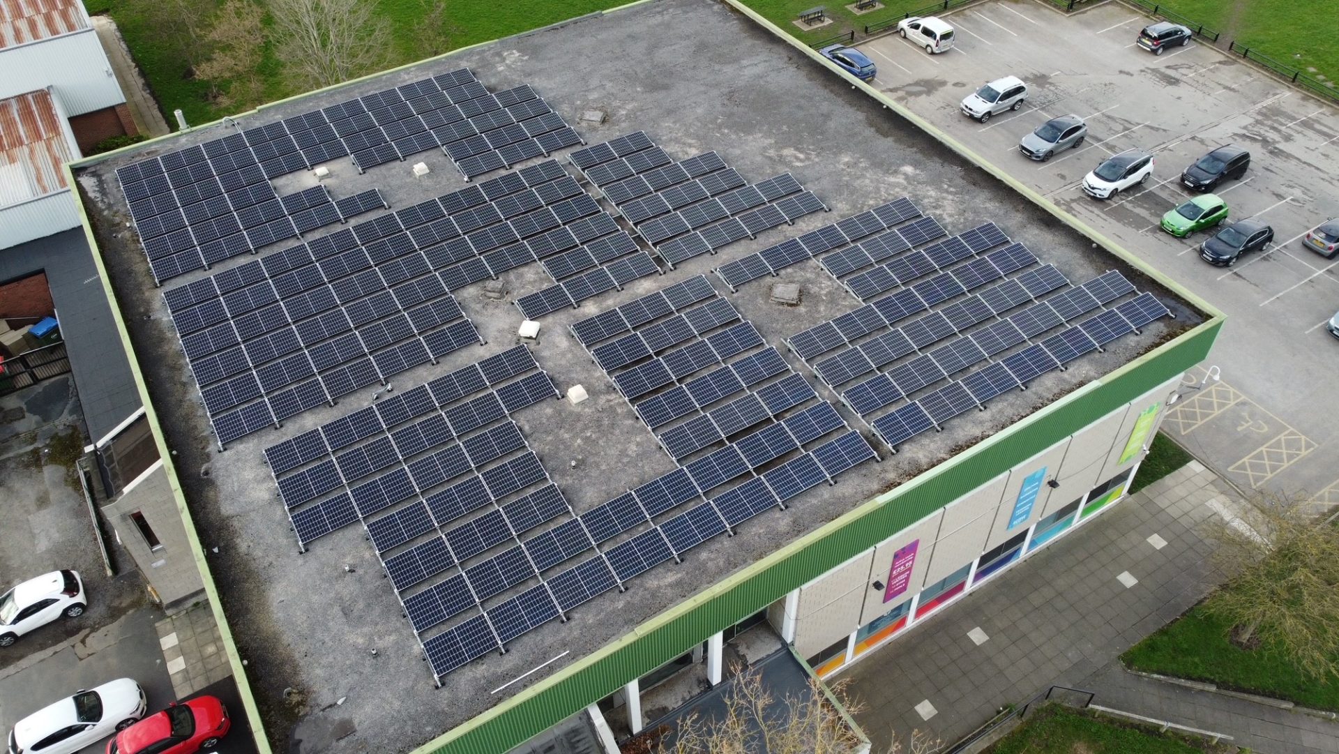 Leeds decarbonisation - View from above of a flat roof building with solar panels.