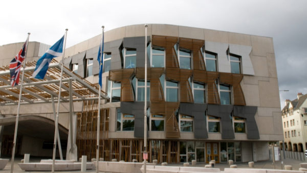 Outside of a modern building with flags outside.