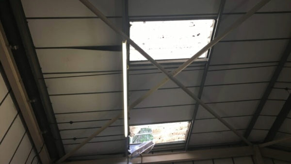 A roof in an industrial estate with gaps