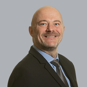 Mugshot of a man smiling at the camera