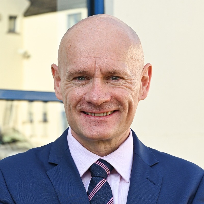 Mugshot of a man smiling at the camera