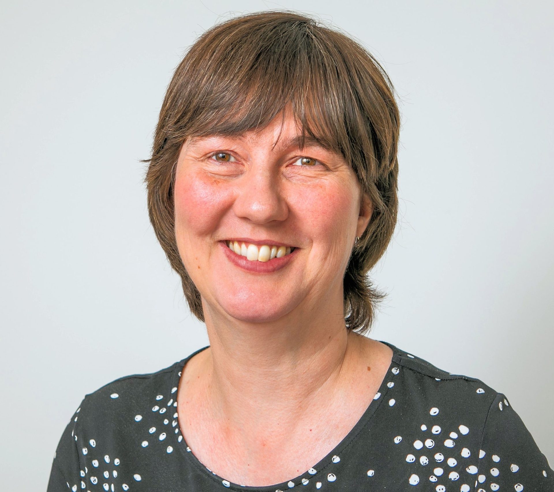 Mugshot of a woman smiling at the camera.