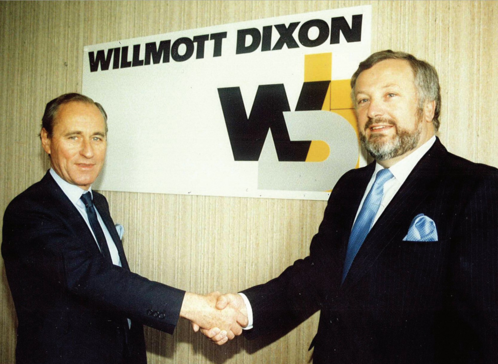 Peter Willmott and Sir Ian Dixon shake hands on the creation of the Willmott Dixon name.