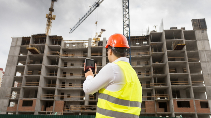 A building controller inspecting a building under construction