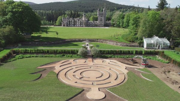 Aerial view of a maze and a castle in the background.