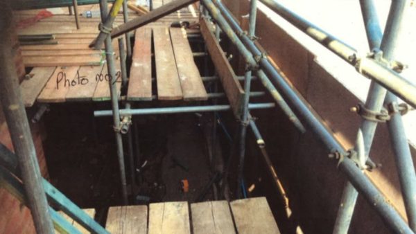 Detail of some wood scaffolding with a big gap.