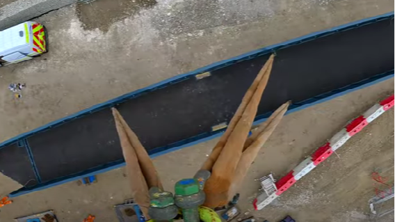 Drone view of a pedestrian bridge being installed.