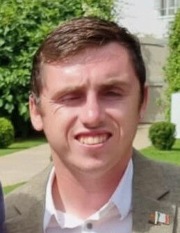 Mugshot of a man smiling at the camera