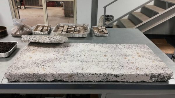 An insulating panel and tile with coarse ash