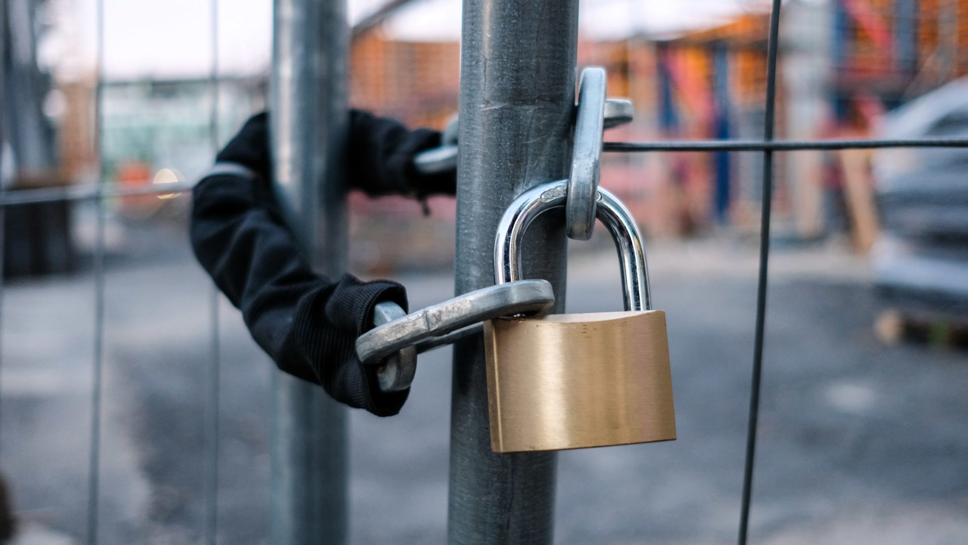 employees rights - Chain and padlock on gate at construction site - a legal expert from Womble Bond Dickinson explains in this article what happens to employees when a contractor collapses.