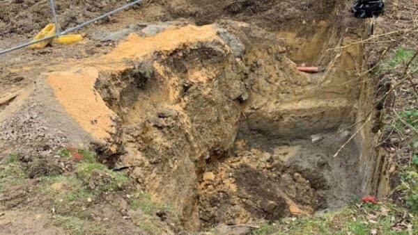 The excavation on the ground that the men were working on when it collapsed. A company and its director have been fined as a result.