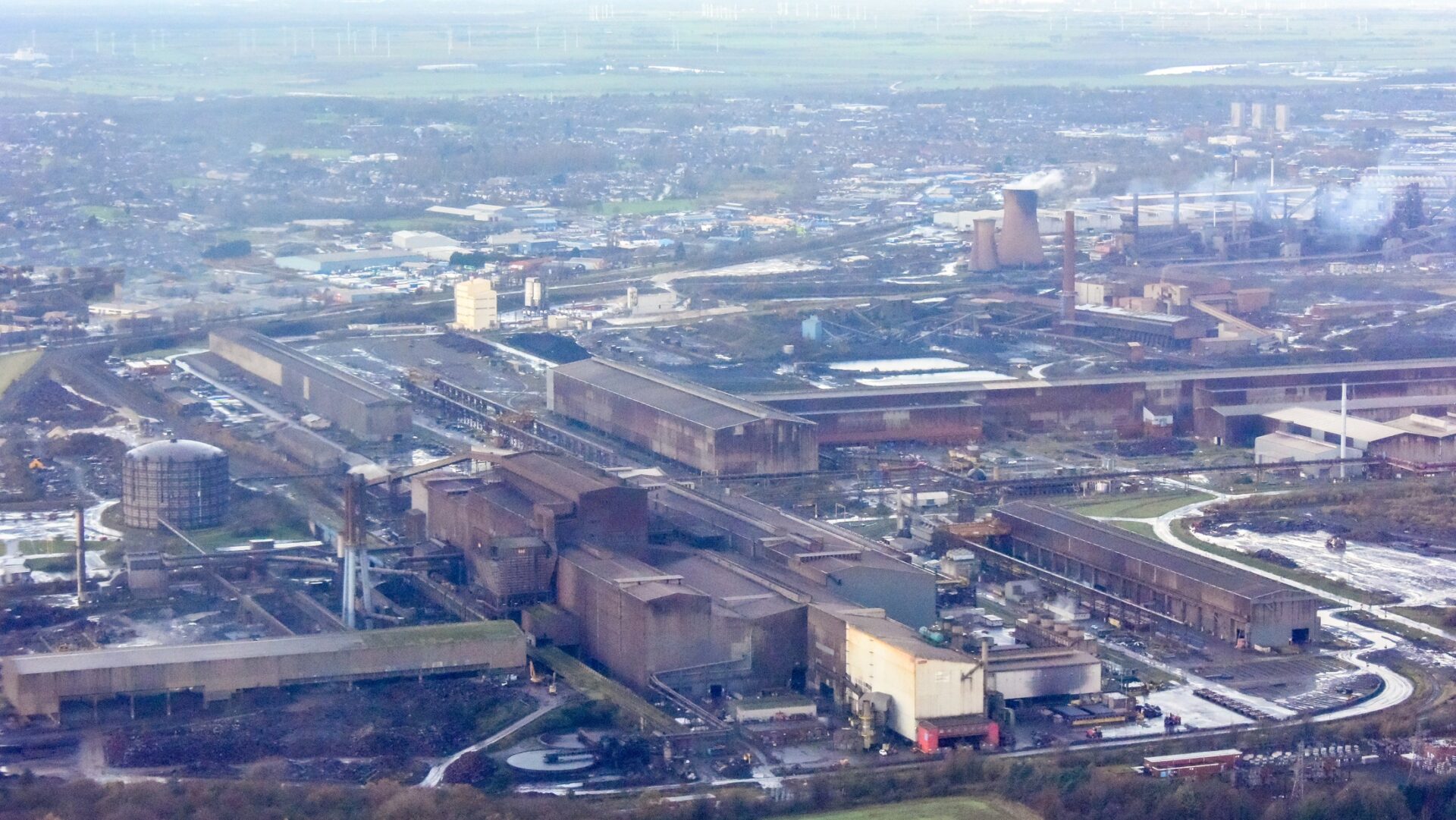 An enormous steel plant in the middle of Scunthorpe producing all sorts of large scale steel items, seen from above - a trade body is asking government to reach a resolution with British Steel's owner.