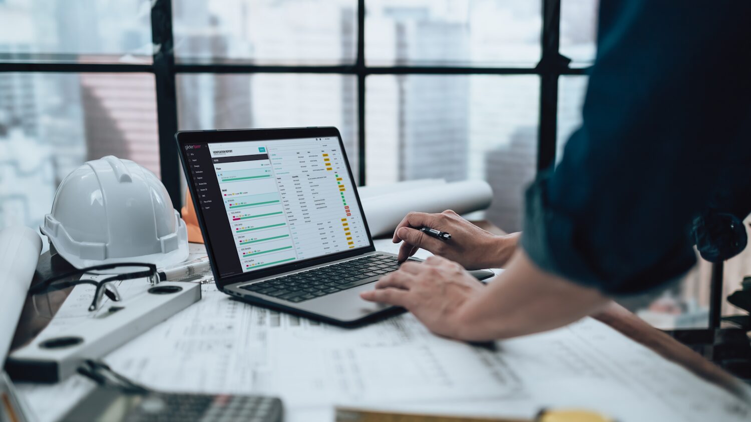 Image of someone using Glider Technology platform on a laptop for project handover contractor explainer