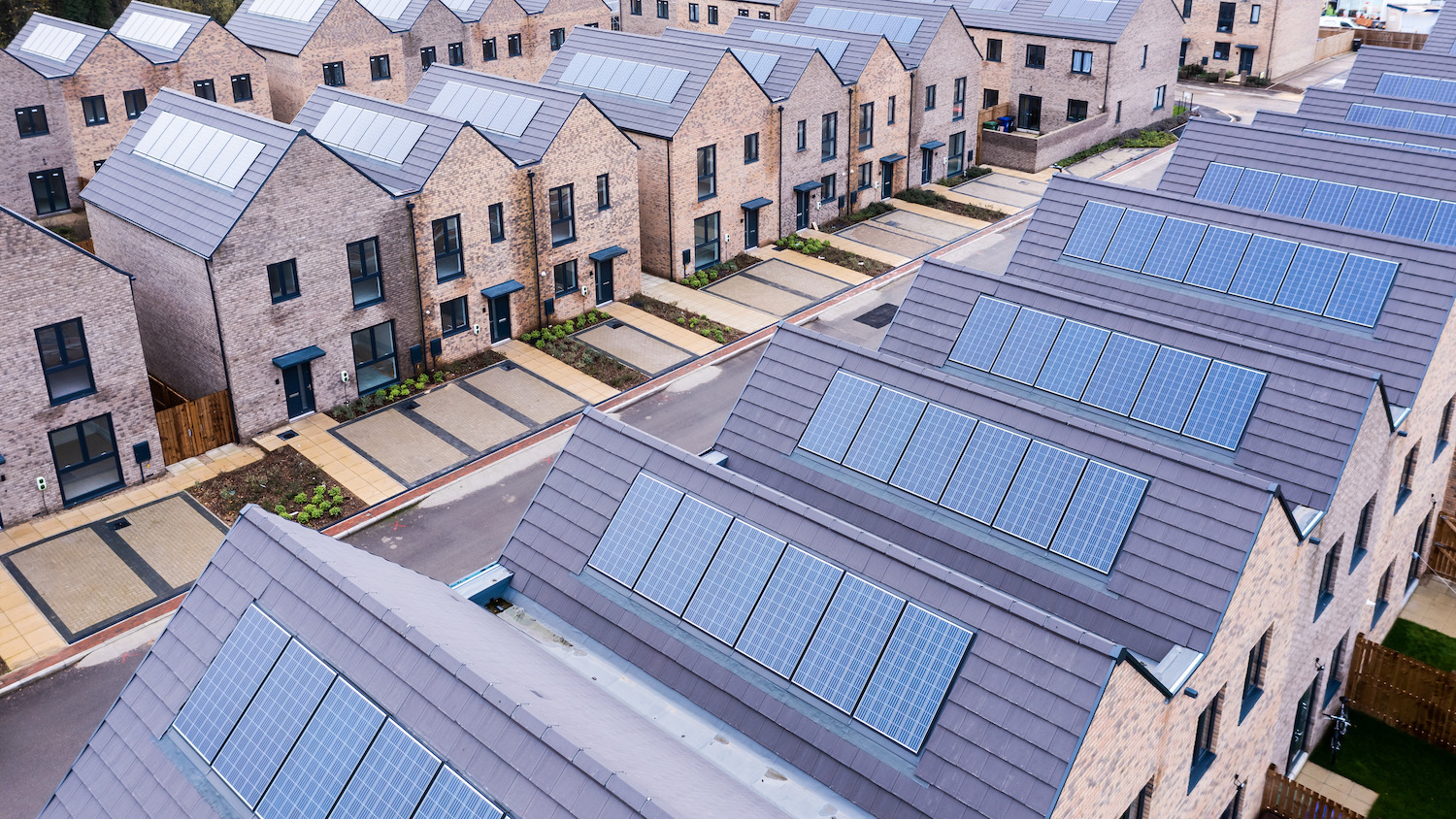 Rows of new-built homes with solar panels on their roofs - the government is going to amend building regulations to mandate solar panels on new builts.