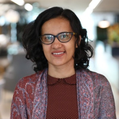 Mugshot of a woman with glassed smiling at the camera - Hema Neethigere shares her experience since losing her job following ISG's collapse