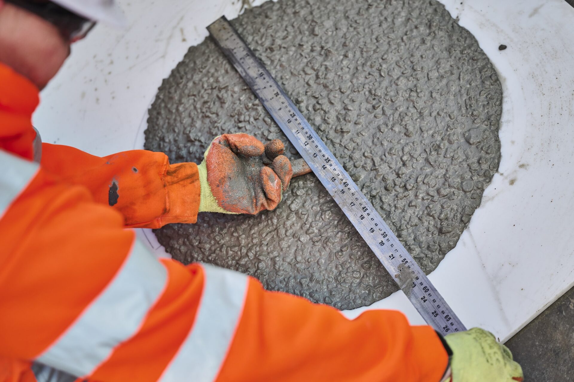 A big circle of cement that someone is measuring - Holcim UK has used a mixture of coffee cement for its base.