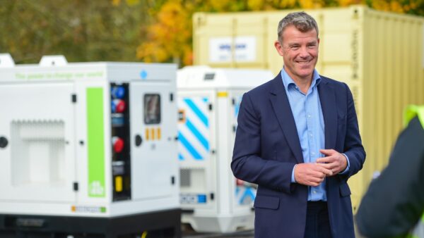 Jonny Wates with the JCB hydrogen generator (image: JCB).