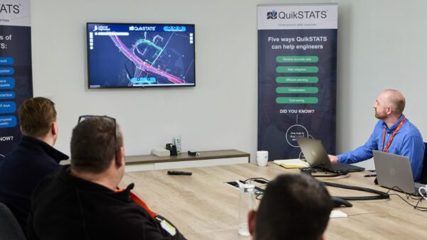 A big table with four men around it looking at a screen showing a digital map - QuikSTATS, part of the Kier Group, has been awarded a contract by National Highways to provide underground utility search data
