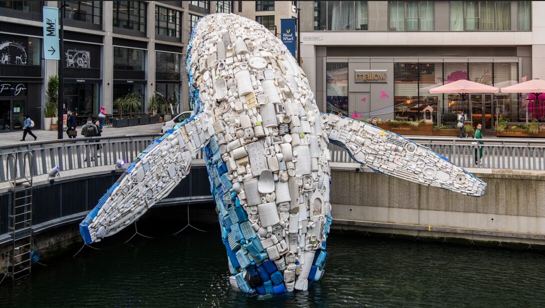 Sculpture of a big blue whale coming out of a dock - Holcim UK has used a mixture of coffee cement for its base.