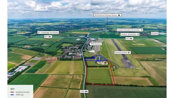 Aerial view of a big green field. Red and blue lines indicate where the Duxford AV Tech and IWM Lab will be located. Henry Boot's development arm has been selected as preferred developer.