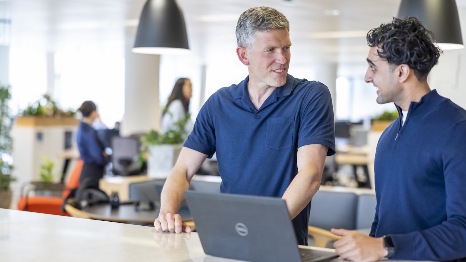 Photo of two men talking, to illustrate SMEs digital construction guide from RLB Digital