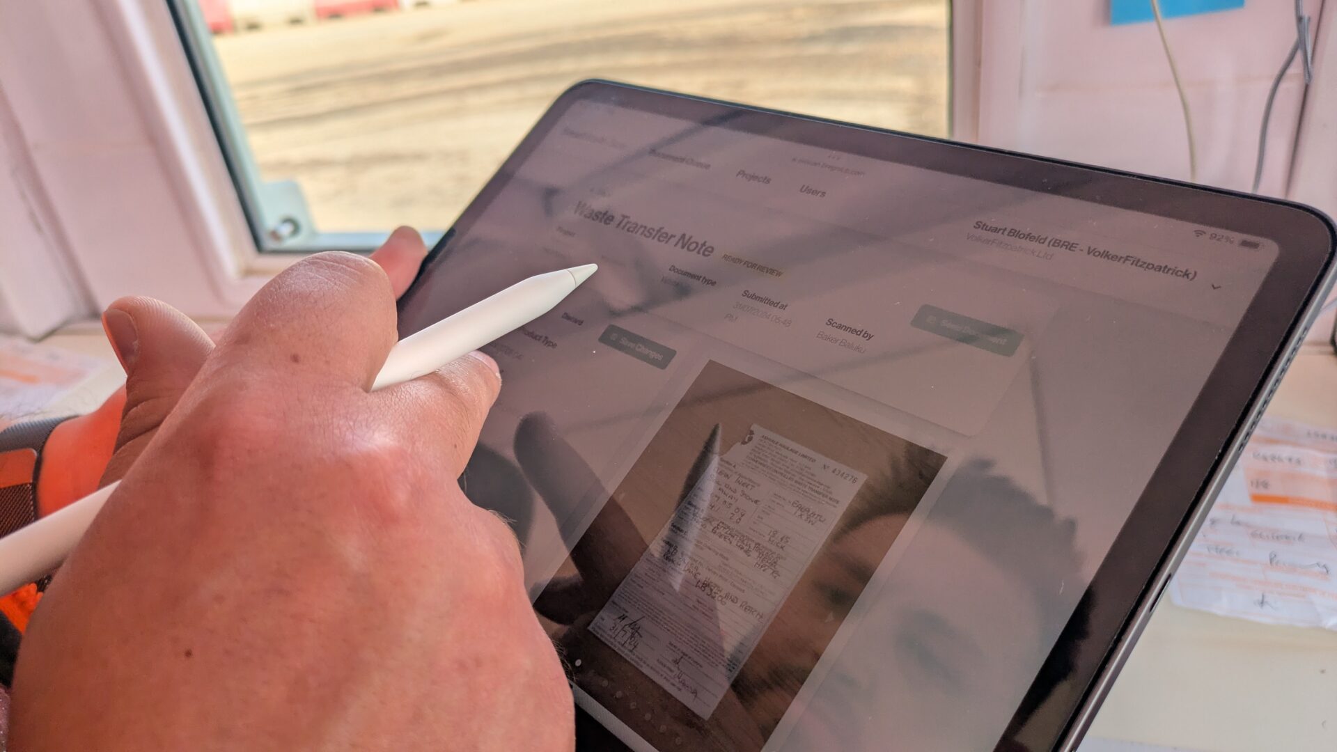 A pair of hands holding a tablet and a pen - Digital Construction Awards 2025: Digital Innovation in Productivity - Smartwaste Scan | Cielo Costa/BRE Group entry