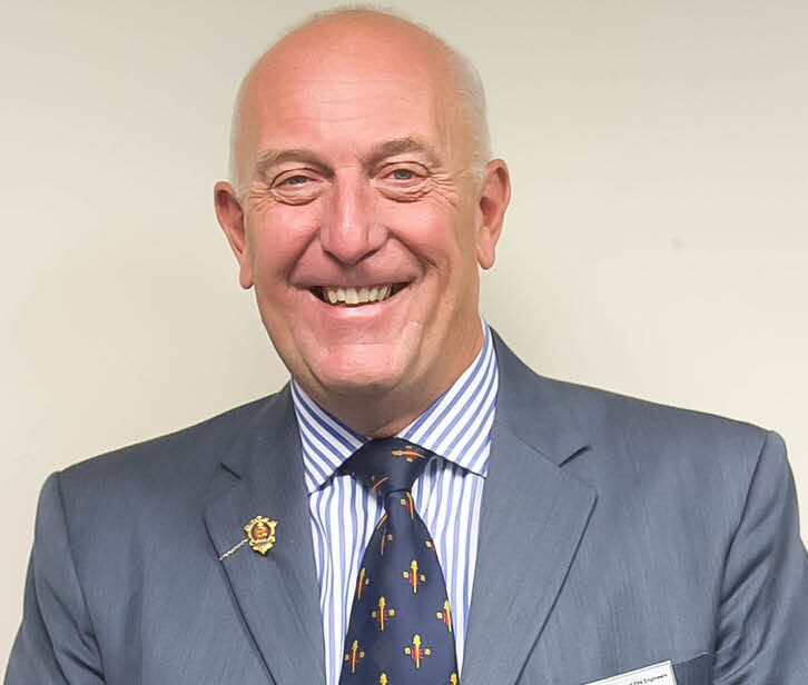 Mugshot of a man with suit and tie smiling at the camera - in this article, Neil Gibbins discuss how mass fatality nightclub fires can be prevented.