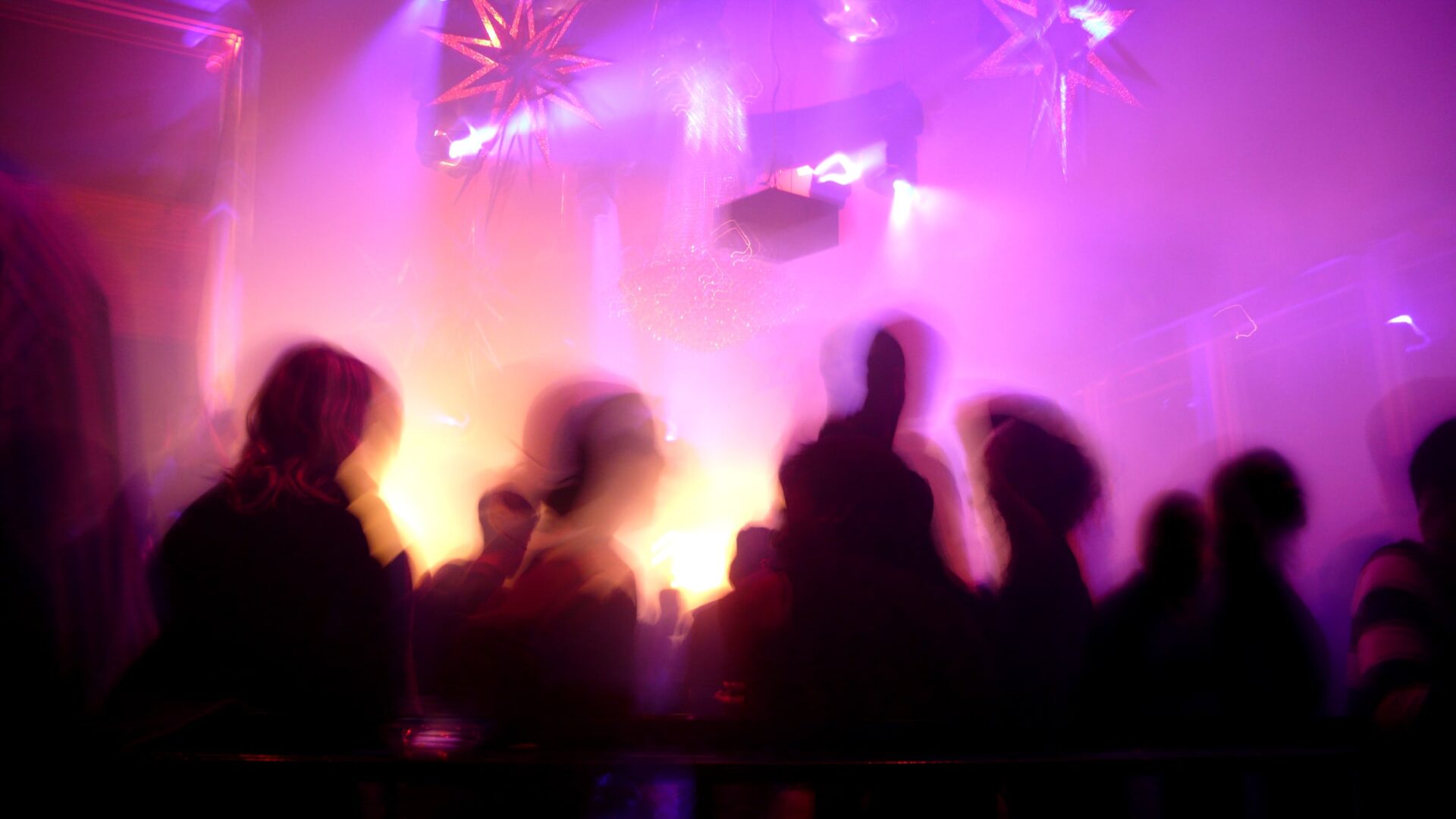 nightclub fires - Dance floor inside a night club with blurred crowd in motion - this article discussed how mass fatality nightclub fires can be prevented.