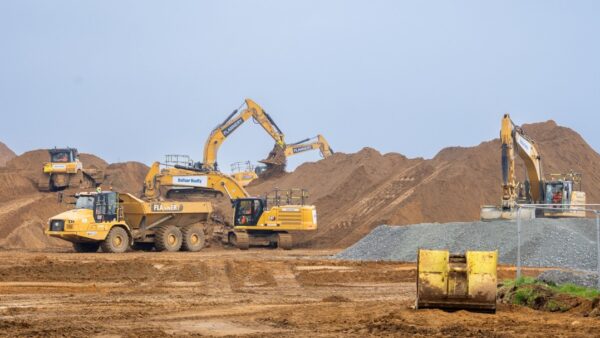 Yellow excavators moving earth in a big construction site - Sizewell C forms civils alliance with three construction giants
